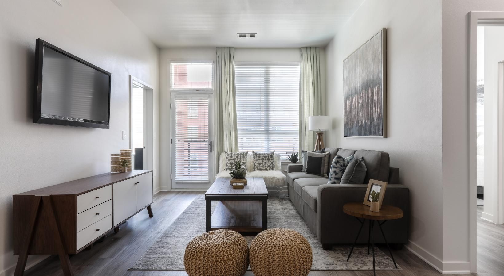 Wide open living areas flooded with natural light a living room with a tv and couches