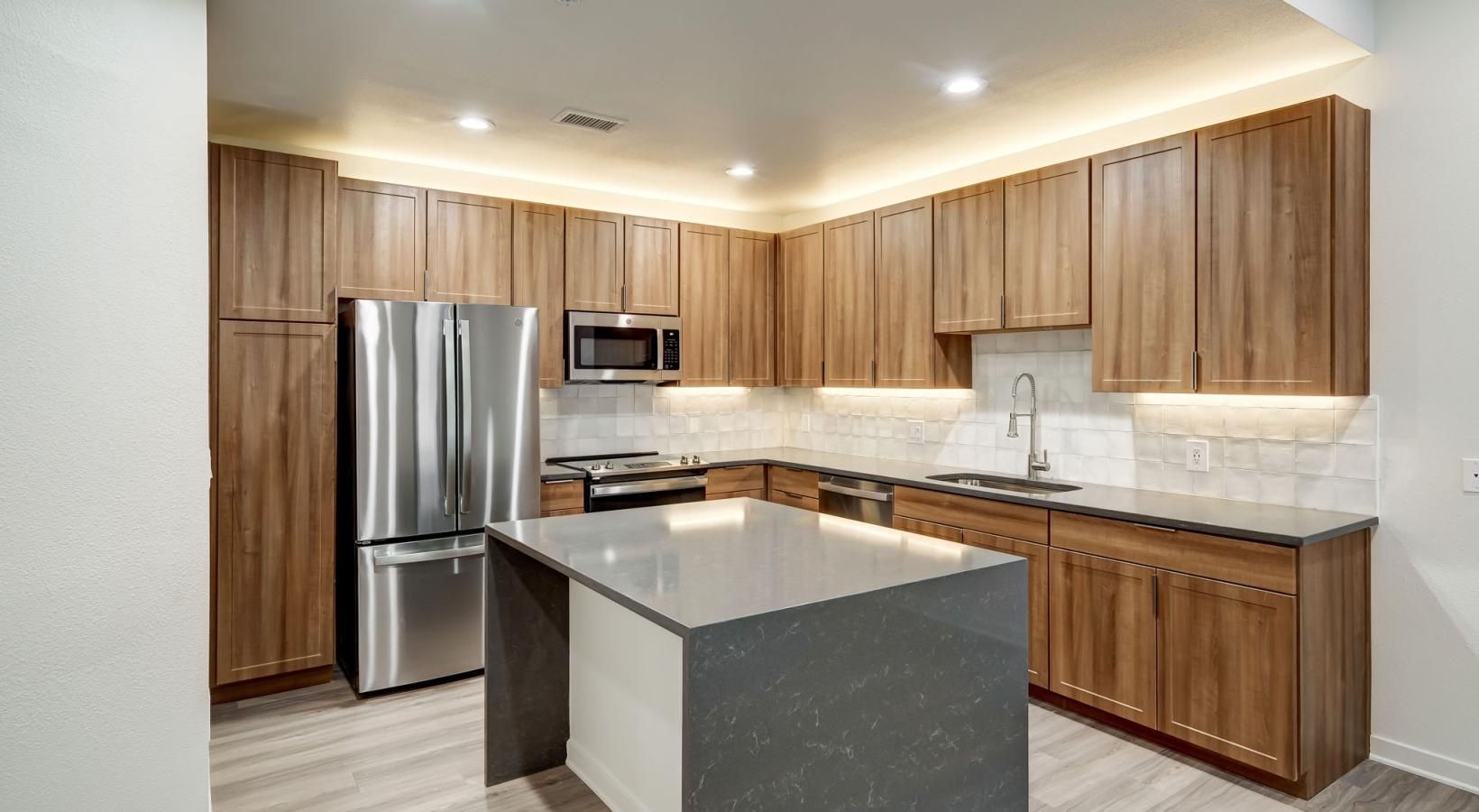 Spacious kitchens with thoughtful details a kitchen with wooden cabinets