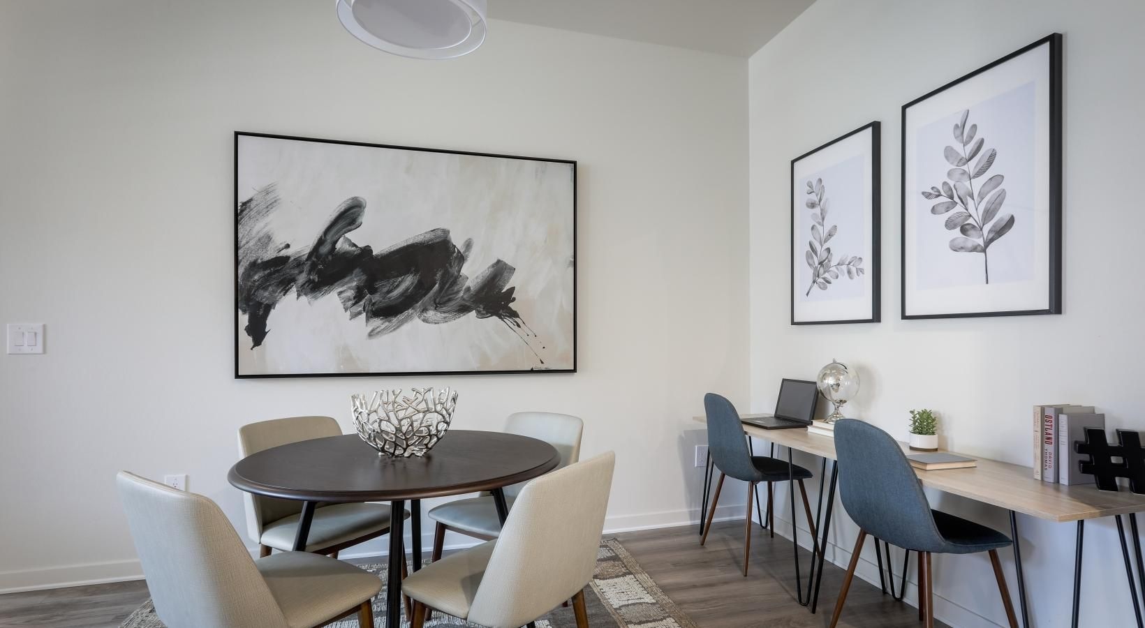 Wide open living areas perfect for entertaining a room with a table chairs and a painting on the wall