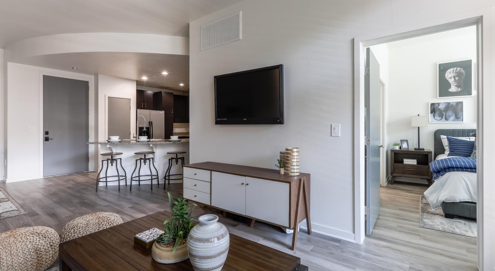 Spacious living areas to recline and recharge a living room with a tv and a table