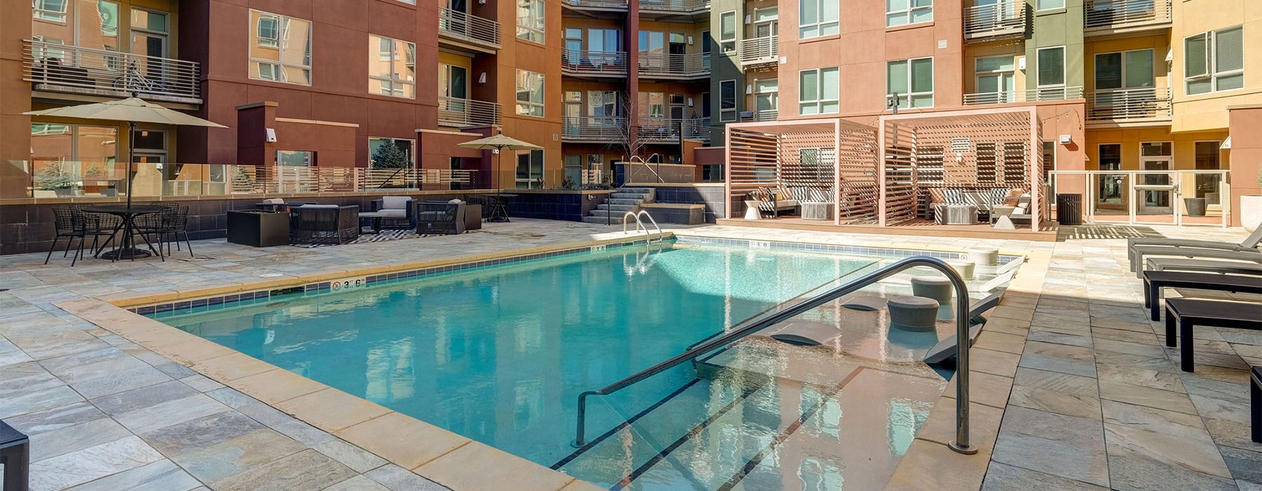 a pool in a courtyard between buildings