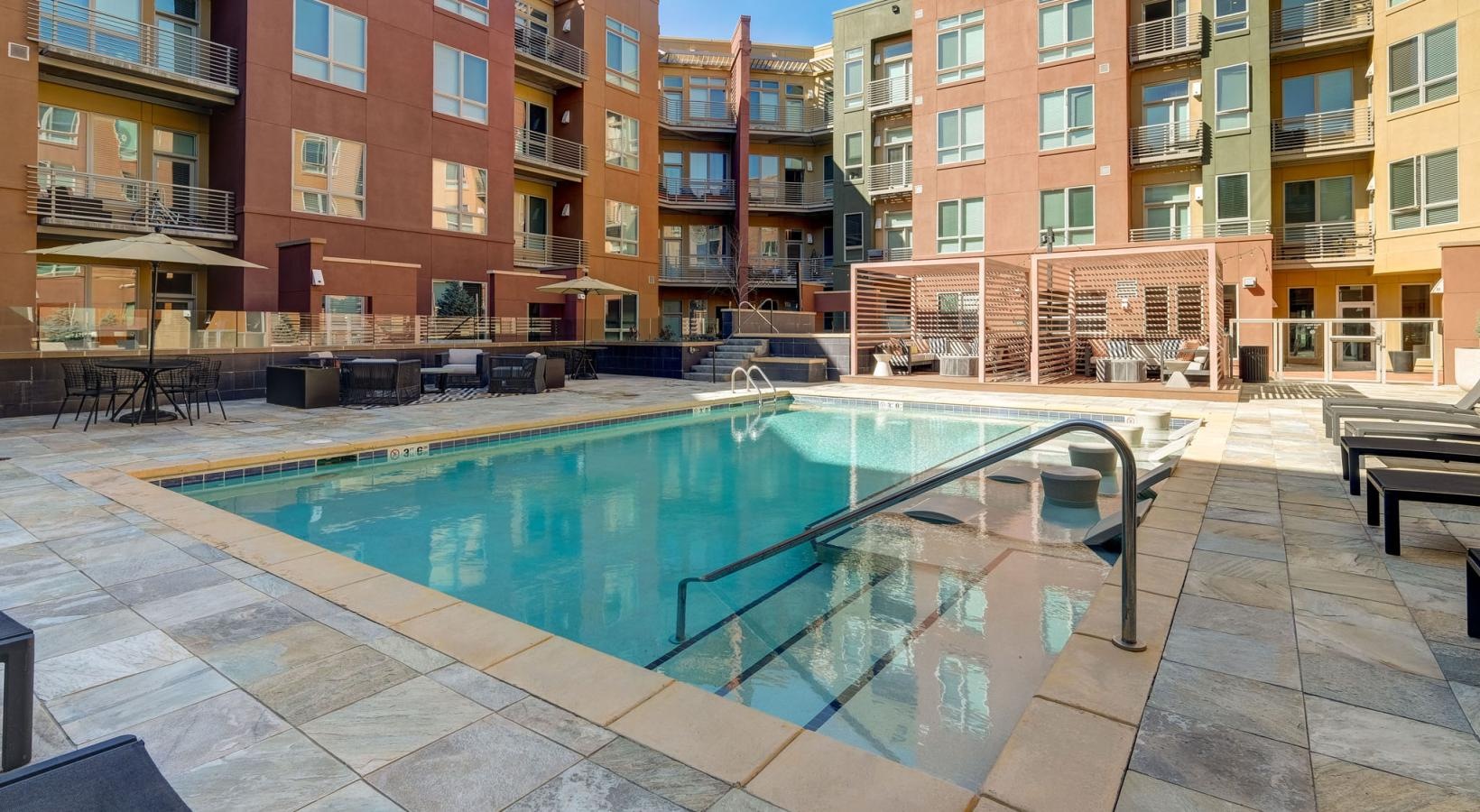 Shimmering resort-style pool a pool in a courtyard between buildings